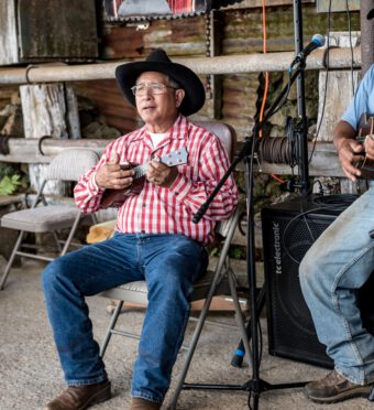 Paniolo playing ukelele at Parker Ranch